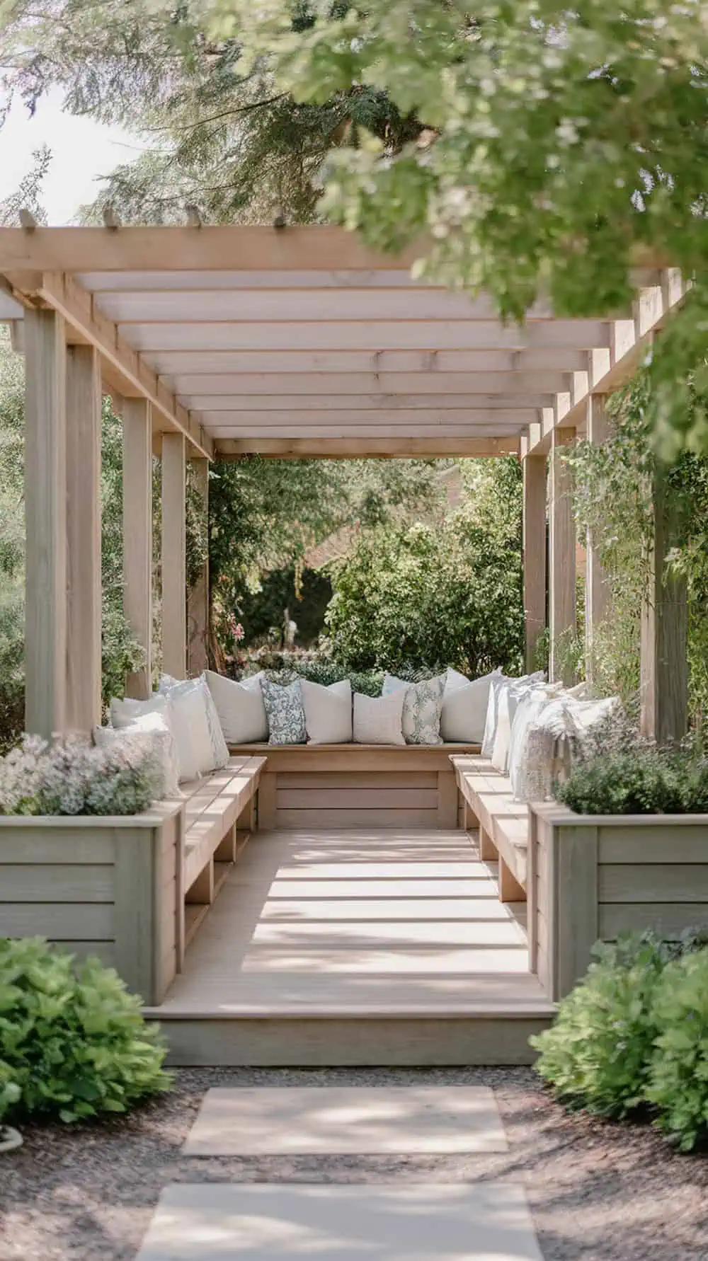 A beautiful pergola with built-in benches and planters, surrounded by greenery.