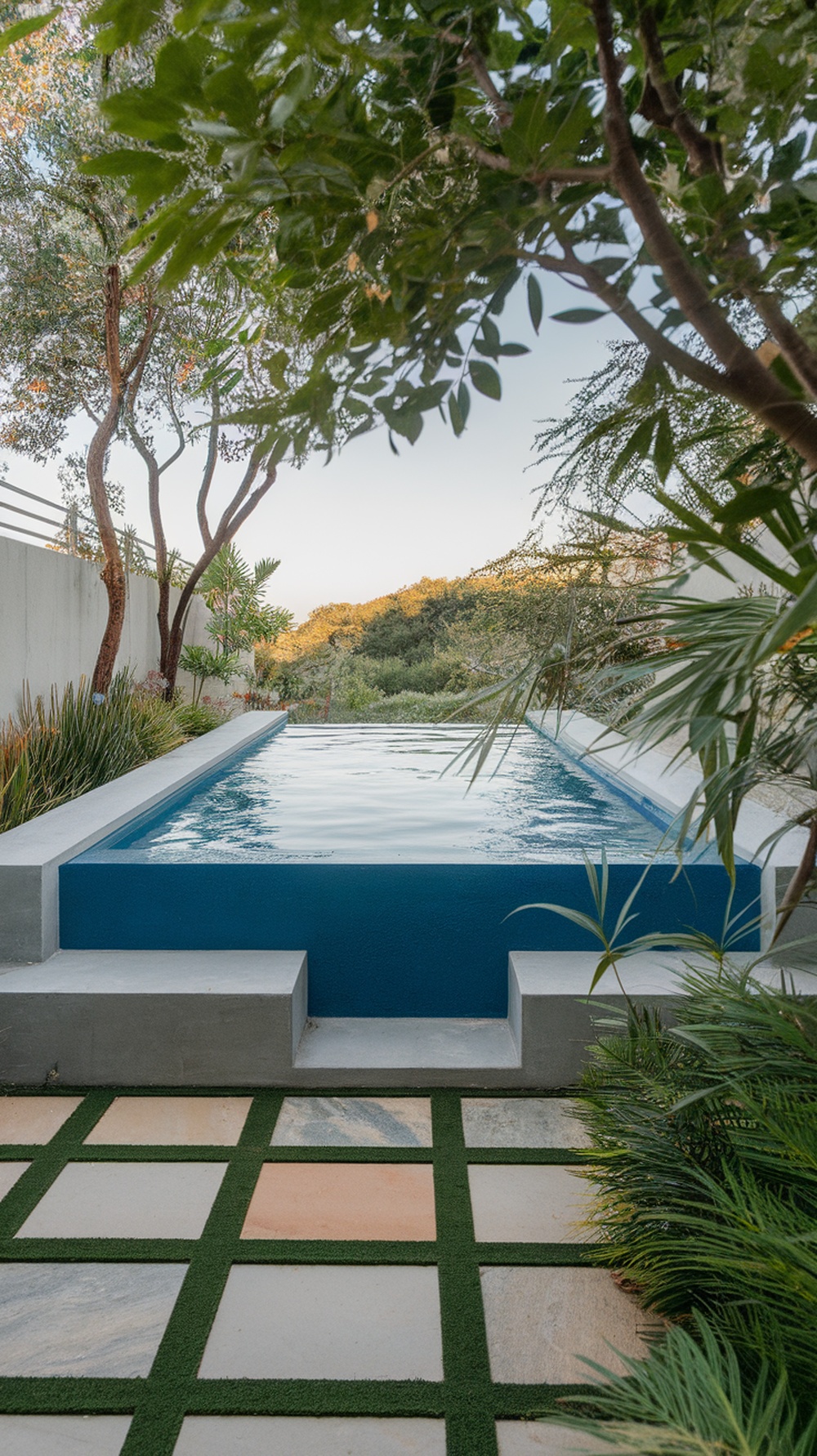 A raised pool surrounded by greenery and built-in seating.