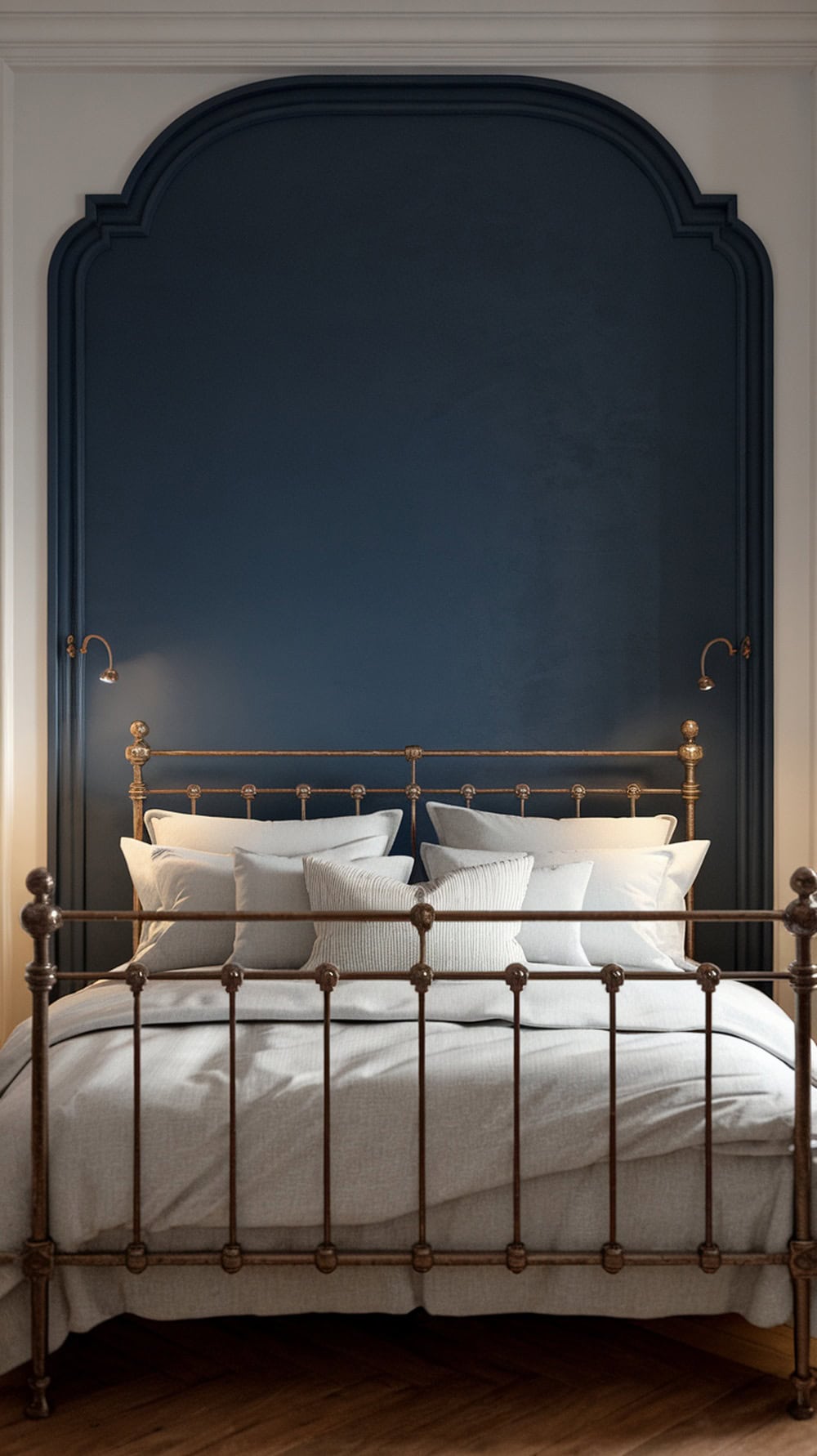 A cozy bedroom with a French blue accent wall and an iron bed.