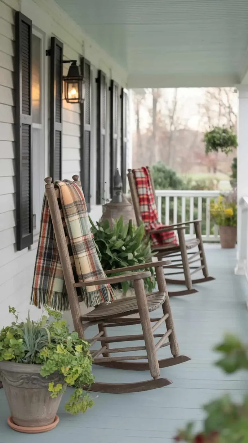 Plaid throws on rocking chairs on a farmhouse porch