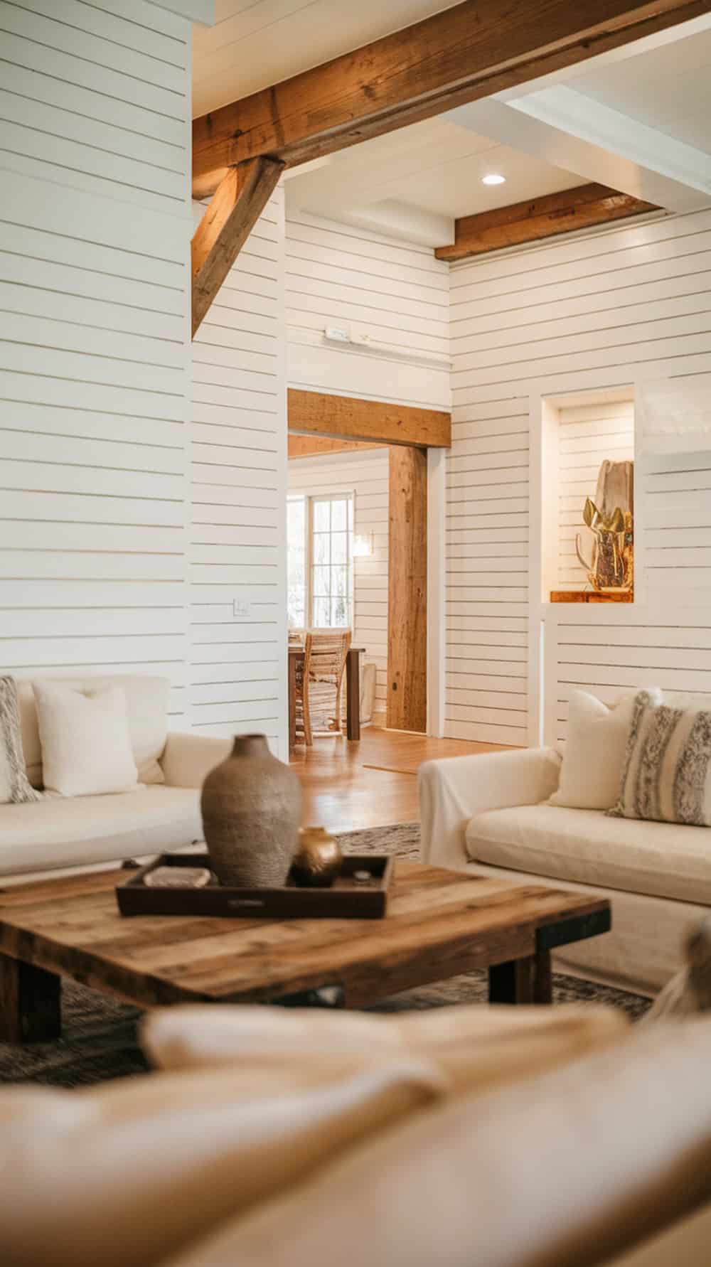 Living room with white shiplap walls and warm wood accents